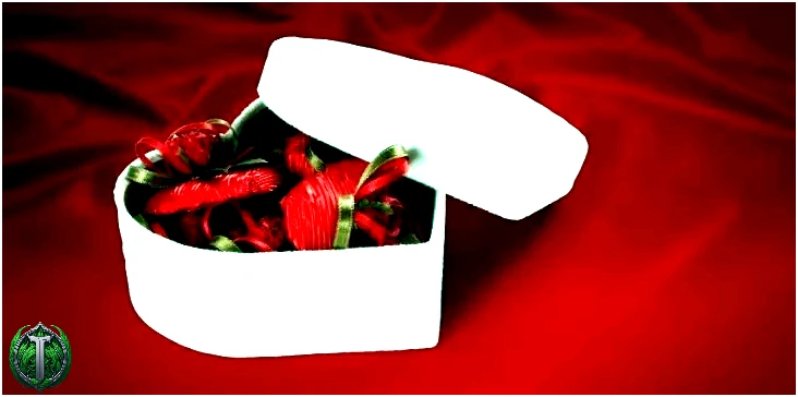 Біла коробка у формі серця з шоколадом всередині, індивідуально загорнута в темно-червоний папір